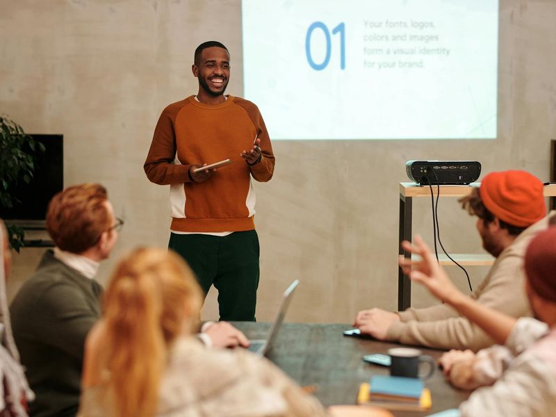 A diverse group of people smiling in a bright, welcoming room.